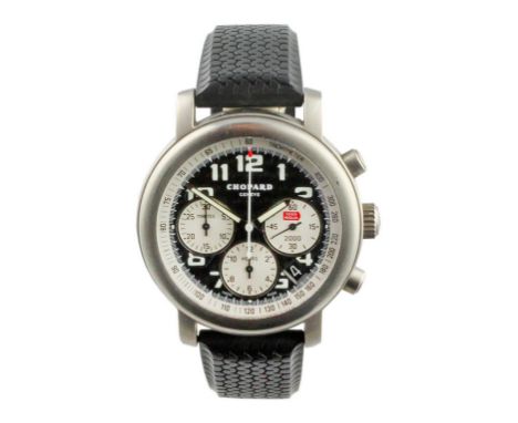Black carbon dial with large Arabic luminous hour markers and tachymeter in outer edge. The 1000 Miglia symbol is in the righ
