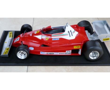 A fine 1/8 scale model of a Ferrari 312T3 complete with its perspex display case, 72cmx36cm.