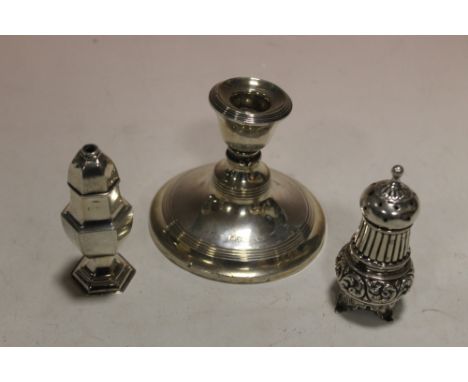 TWO HALLMARKED SILVER PEPPERETTES PLUS A HALLMARKED SILVER CANDLESTICK