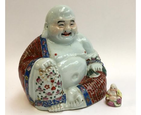 Two Chinese ceramic Buddhas, one 25cmH, the other 5cmH
