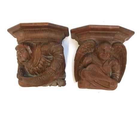 A pair of early 20th century Continental hand carved oak wall mounts, in the form of a monk and and an angel with lute, 19cmH