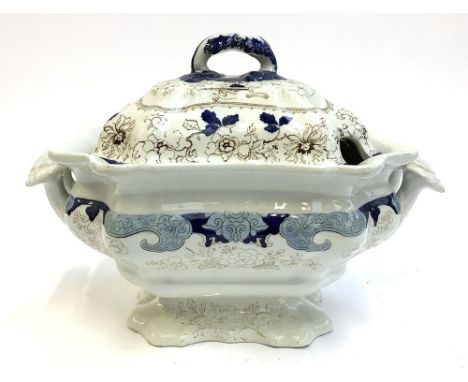 A blue and white ceramic tureen, intricately decorated with floral patterns, handles in the form of oak leaves, marked to bas