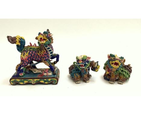 A Wucai glazed polychrome Tang style ceramic Qilin figure, 17cmH, together with two Wucai polychrome ceramic Foo dogs, 8.5cmH
