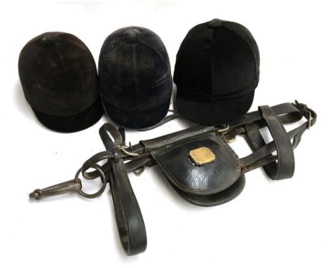 A shire horse/cart horse leather bridle with blinkers, together with three vintage riding hats, including the Super Beaufort 