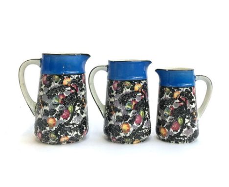 A set of three graduating ceramic jugs, Chinese lanterns amongst trees design, the largest marked '1773' to base, 18cmH, 17cm