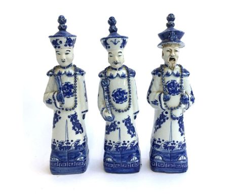 A set of three Chinese blue and white ceramic Qing Dynasty Emperor figures, depicting three generations of the grandfather, f
