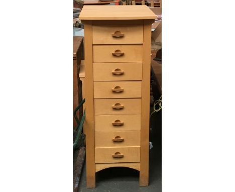 A contemporary chest of eight drawers in light ash, together with a small occasional table, 133cmH 