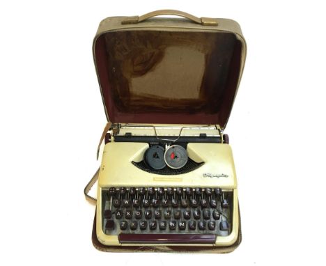 An Olympia typewriter in travel case, together with a Nenette dust absorbing polisher 