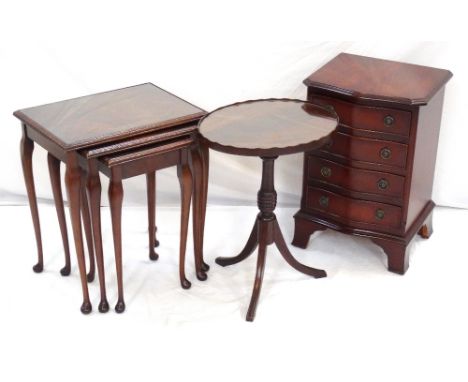NEST OF THREE MAHOGANY TABLESwith inset glass tops standing on cabriole supports, 48cm wide; an oval mahogany wine table with