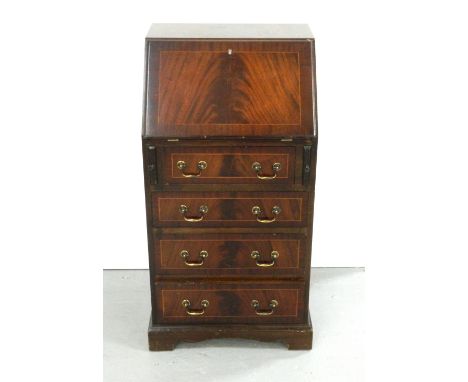MAHOGANY WRITING BUREAUof narrow proportions with a fall flap revealing a fitted interior above four drawers, standing on bra