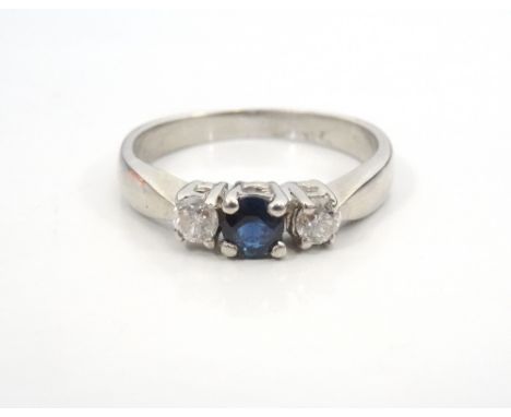 SAPPHIRE AND DIAMOND THREE STONE RINGthe central sapphire approximately 0.2cts flanked by diamonds totalling approximately 0.