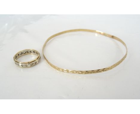 CLEAR GEM SET NINE CARAT GOLD RINGthe decagonal band in two tone gold, ring size L and approximately 2.5 grams; together with