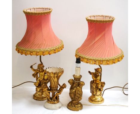 PAIR OF POLYCHROME TABLE LAMPSmodelled as young boys, one playing a drum, the other playing a flute, raised on pedestals with