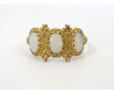 OPAL THREE STONE RINGwith decorative moulded setting, on nine carat gold shank, ring size L