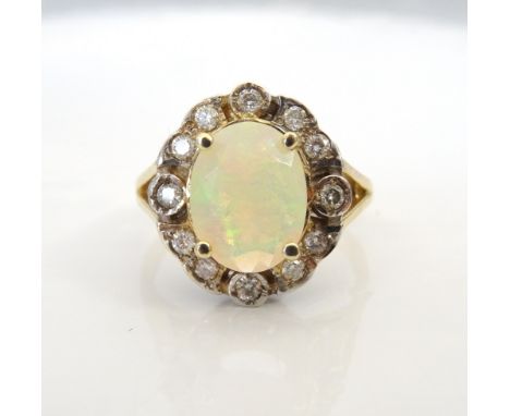 FACETED OPAL AND DIAMOND CLUSTER RINGthe central diamond in twelve diamond surround totalling approximately 0.25cts, on nine 