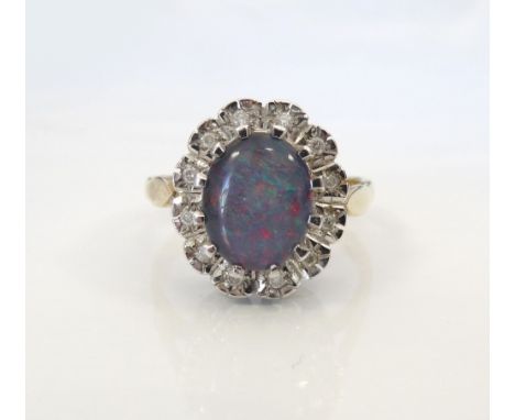 OPAL TRIPLET AND DIAMOND CLUSTER RINGthe central opal in twelve diamond surround, on nine carat gold shank, ring size N-O