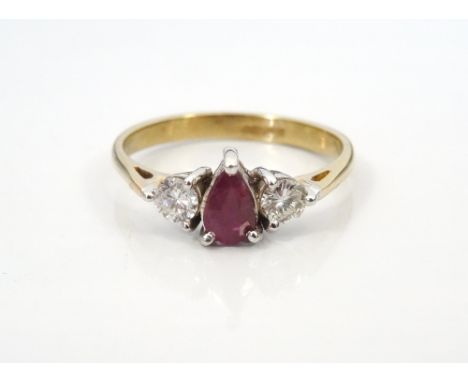 RUBY AND DIAMOND THREE STONE RINGthe central pear cut ruby approximately 0.3cts flanked by round cut diamonds totalling appro