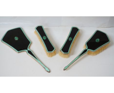 ART DECO SILVER AND ENAMEL DRESSING TABLE SETcomprising hand mirror, pair of brushes, and another brush, each piece set with 
