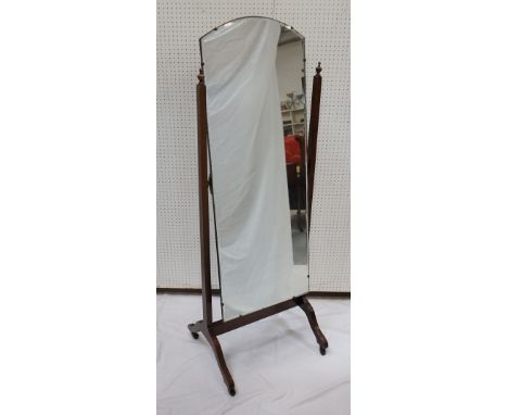 1920's OAK FRAMED CHEVAL MIRRORthe shaped top mirror with bevelled edges, mirror supports with finial detail, raised on shape