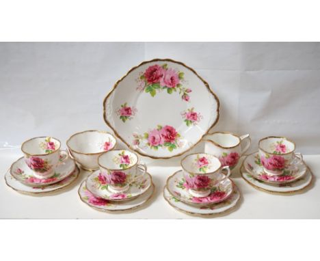 ROYAL ALBERT 'AMERICAN BEAUTY' TEA SERVICEwith a white ground decorated with roses, comprising twelve cups; nine saucers; twe