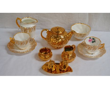 'CLARE' PORCELAIN TEA SERVICEdecorated with roses within gilt ferns and flowers, comprising six cups and saucers, six side pl