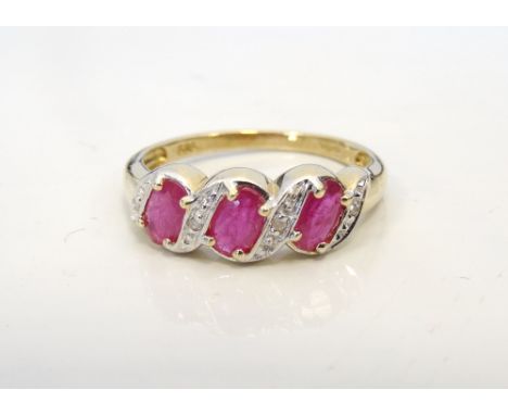 RUBY AND DIAMOND RINGthe three oval cut rubies separated by diamonds, on nine carat gold shank, ring size L