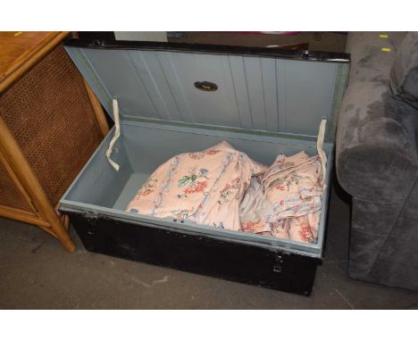 Vintage tin trunk containing curtains