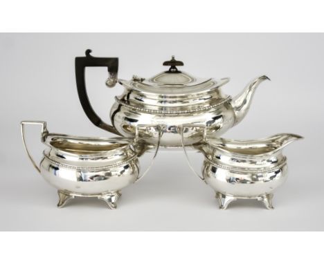 A George VI Silver Oval Three-Piece Tea Service, by Elkington and Co. Birmingham 1944 and 1945, with reeded rims, bead mounts