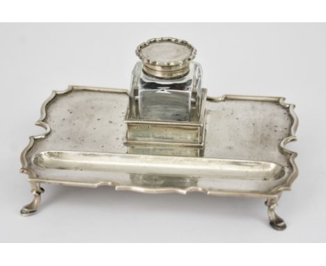 A Late Victorian Silver Rectangular Ink Stand, by Goldsmiths &amp; Silversmiths Co. London 1899, of shaped outline with pen r