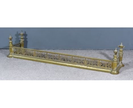 A 19th Century Brass Fender with pierced front and sides, fluted corners with two-handled urn pattern finials, 65ins wide x 1