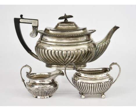A Late Victorian Silver Rectangular Teapot, a Jug and an Edwardian Sugar Basin, all with gadroon mounts and part reeded bodie