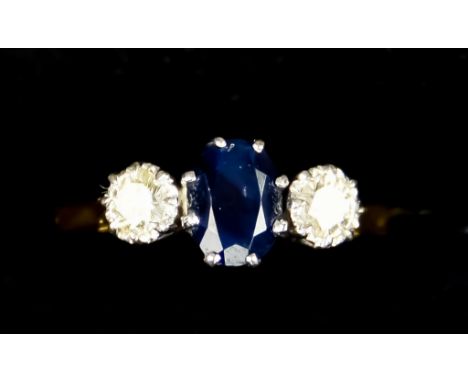 An 18ct Gold Sapphire and Diamond Ring, Modern, set with a centre sapphire, approximately .30ct, flanked by two brilliant cut