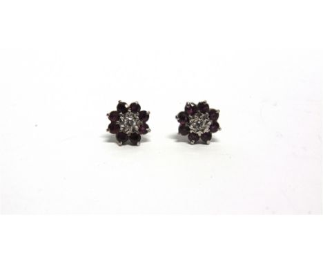 A PAIR OF DIAMOND AND AMETHYST CLUSTER 18 CARAT GOLD EARSTUDS  the central brilliant cut of approximately 0.05 carats, enclos