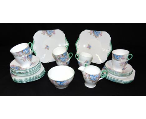 A COLLECTION OF SHELLEY TEAWARE  marked to base Rd No 795072, comprising seven teacups (one cracked), twelve saucers, twelve 