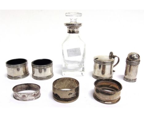 A FOUR PIECE SILVER CRUET SET Birmingham 1937, comprising a mustard pot; a pair of salts; and a pepper; two silver napkin rin