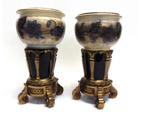 A PAIR OF VICTORIAN POTTERY VASES WITH GILT BRASS STANDS  and gilt liners, stamped to the cast iron bases 'MESSENGER', the ce