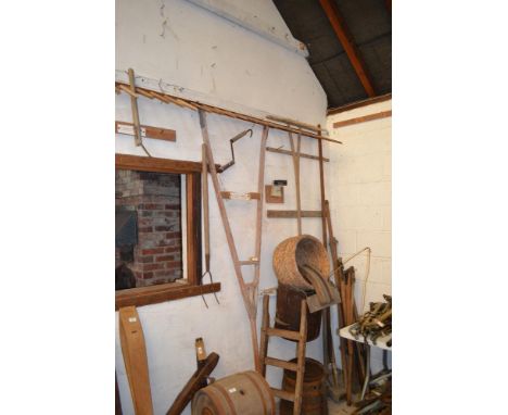 A large quantity of hand tools and sundries to include bushell measure, hobby rake, pitch fork, various flails etc.