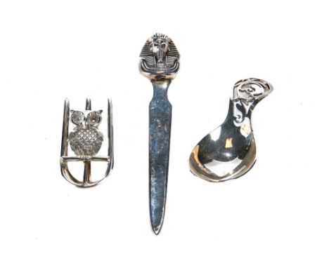 A MODERN SILVER OWL MOTIF MONEY CLIP, maker:- SJR, Birmingham 1979, a ditto pierced handled CADDY SPOON, maker:- DNH &amp; Co