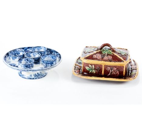 A 19TH CENTURY STAFFORDSHIRE MAJOLICA BROWN GLAZED DISH AND COVER with moulded leaf decoration and integral base, 8 1/2 ins x