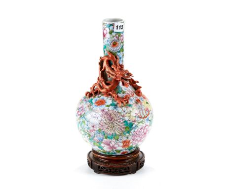 A LATE 19TH CENTURY CHINESE MILLE FLEUR GROUND BOTTLE VASE, the neck decorated with a dragon chasing a flaming pearl, red sea