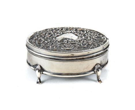 AN EDWARDIAN OVAL FOLIATE EMBOSSED SILVER TRINKET BOX raised on four cabriole legs, maker:- WDB, London 1905.   