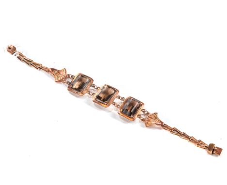 A CONTINENTAL YELLOW METAL THREE-PANEL SMOKEY QUARTZ BRACELET, old repair, total weight 13.5 grams.   