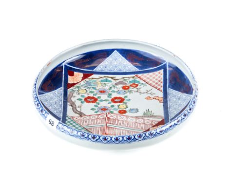 A LARGE LATE 19TH CENTURY JAPANESE PORCELAIN BOWL decorated with a square panel of a bird, tree and trellis fence, blue groun