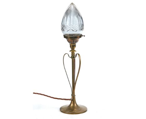 AN EDWARDIAN ART NOUVEAU BRASS TABLE LAMP, central brass column with three central brass scroll arms, on a circular brass bas
