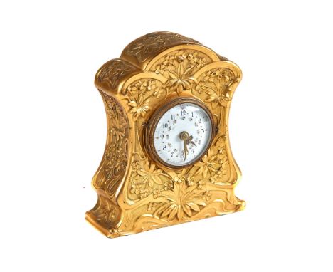 AN EDWARDIAN ART NOUVEAU INFLUENCE GILT METAL MANTLE CLOCK circular floral enamelled dial with platform escapement, in a foli