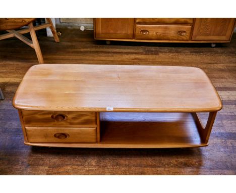 AN ERCOL LIGHT ELM "MINERVA" COFFEE TABLE of rounded corner rectangular form with two drawers and open area, 49 ins x 21 ins.