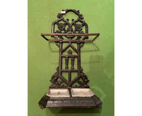 A CAST METAL STICK/UMBRELLA STAND WITH BOTH TRAYS 