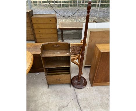 AN OAK MAGAZINE RACK AND A MAHOGANY STANDARD LAMP 