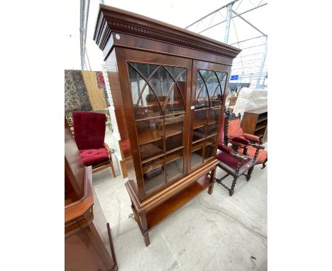 A MAHOGANY BOOKCASE CABINET WITH TWO GLAZED PANEL DOORS AND LOWER SHELF 