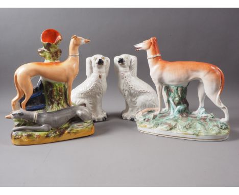 A 19th century Staffordshire greyhound spill vase, 11" high, a 19th century Staffordshire greyhound and hare model, and two s